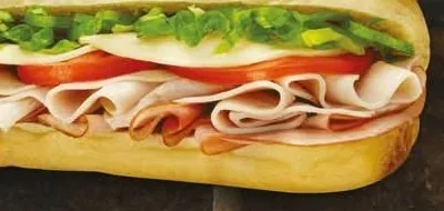 Sandwich froid garni de dinde, tomates et salade